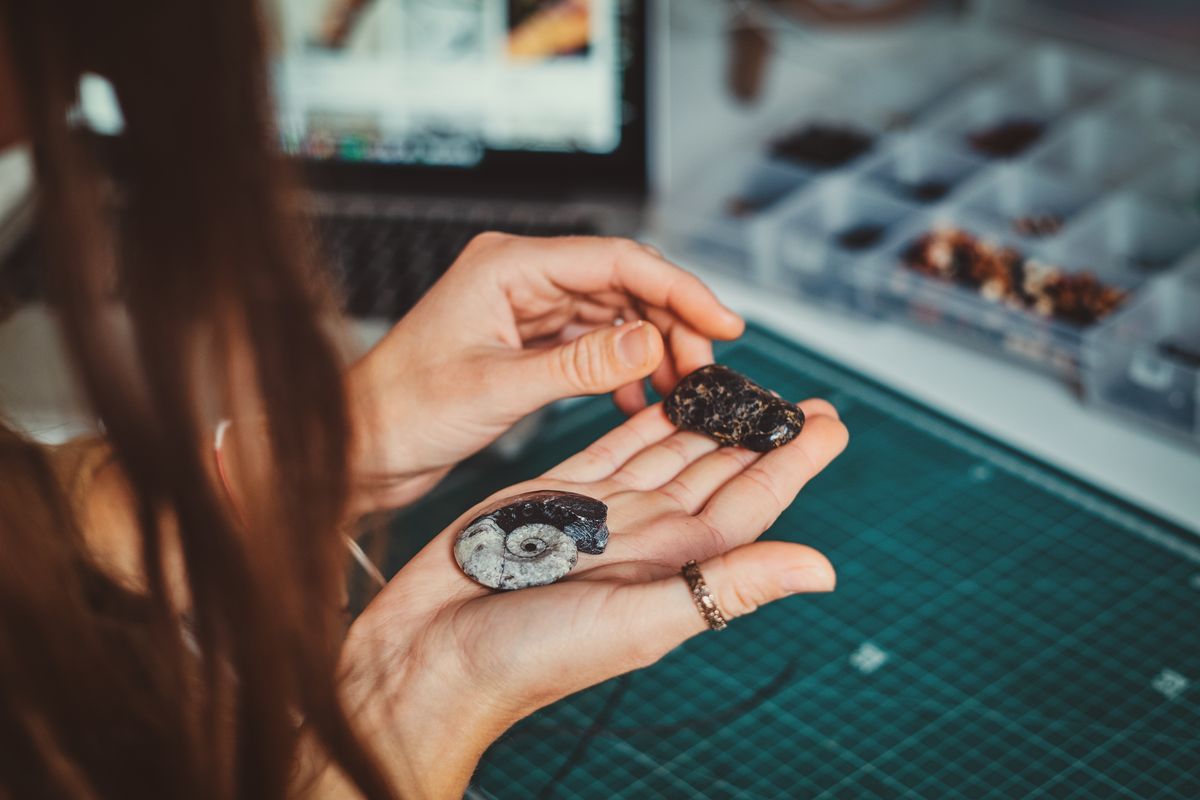 Girl is choosing nice shell for her jevellery
